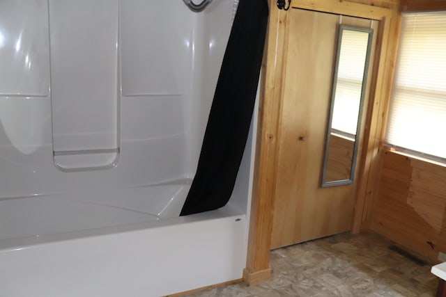 details with tub / shower combination and tile patterned floors