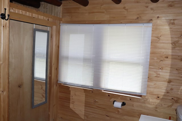 details with ceiling fan and wooden walls