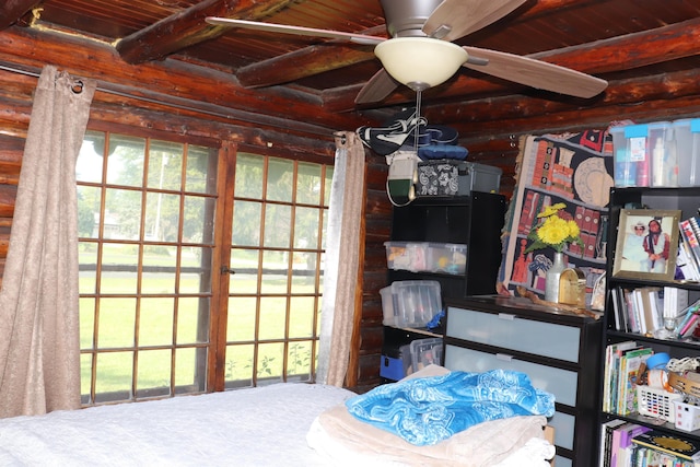 unfurnished bedroom with ceiling fan, beam ceiling, and wood ceiling