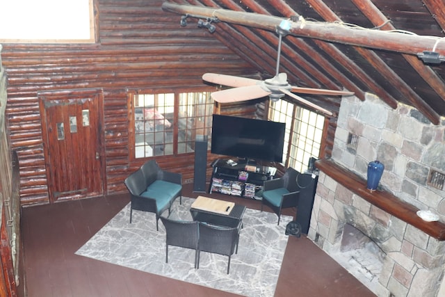 living room with log walls, wood-type flooring, and vaulted ceiling with beams