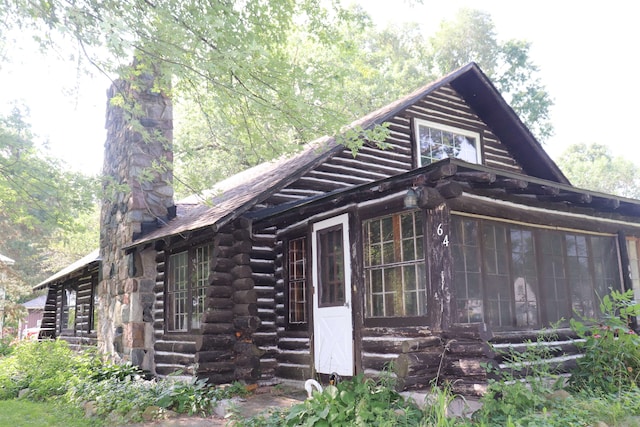 view of side of home with a sunroom