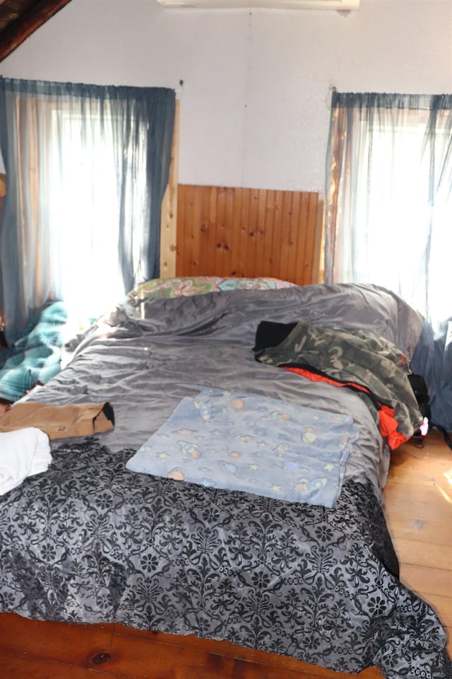 bedroom featuring wood-type flooring and multiple windows