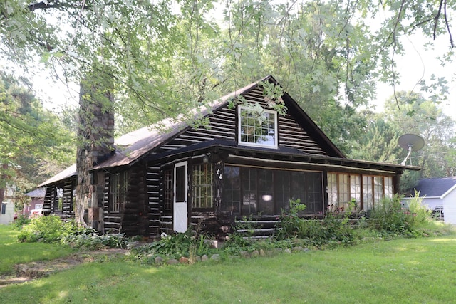 exterior space featuring a front yard and a sunroom