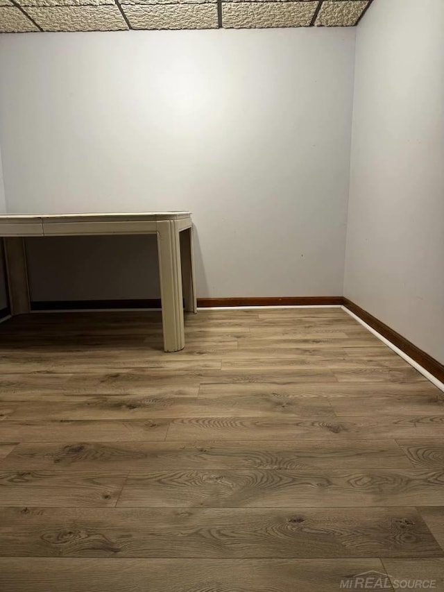 interior space with wood-type flooring and a paneled ceiling