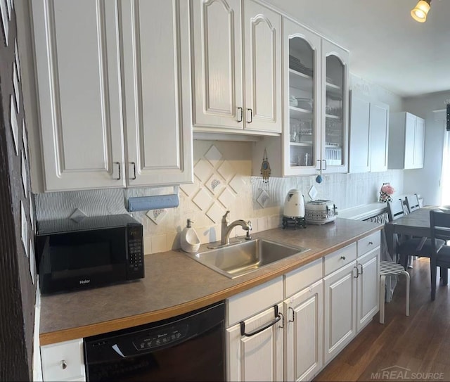 kitchen featuring tasteful backsplash, sink, white cabinets, black appliances, and dark hardwood / wood-style floors