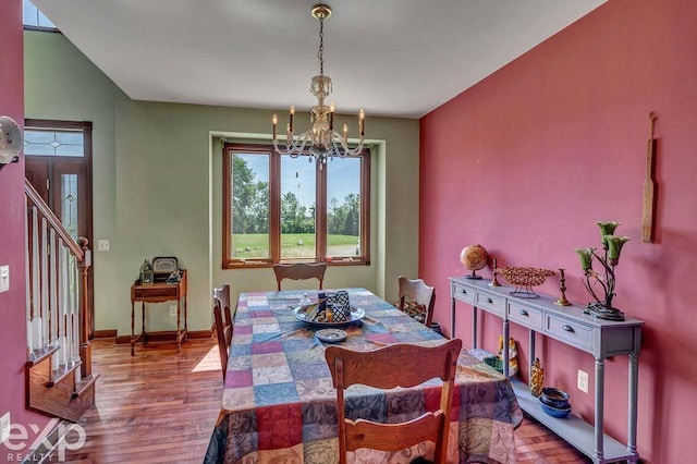 dining room featuring hardwood / wood-style floors and a chandelier