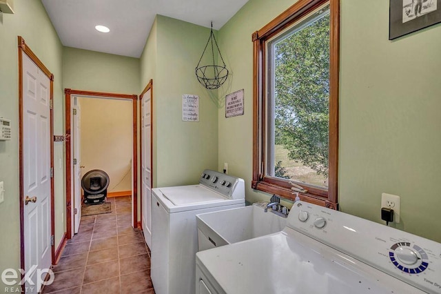 clothes washing area featuring sink, tile patterned floors, and independent washer and dryer