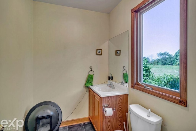 bathroom featuring vanity, tile patterned flooring, and toilet