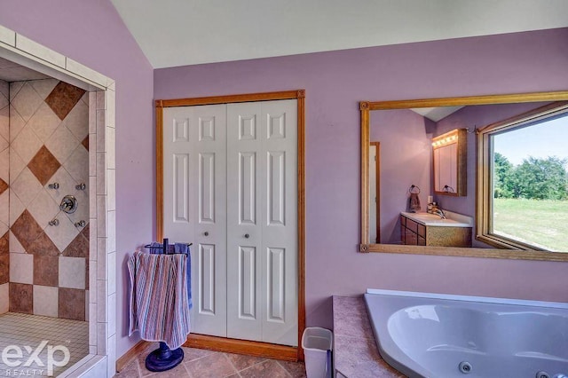 bathroom with vanity, plus walk in shower, and tile patterned flooring