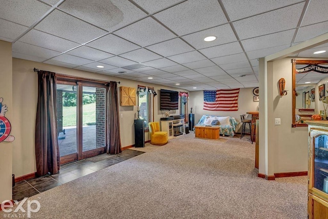 interior space featuring a drop ceiling and dark tile patterned floors