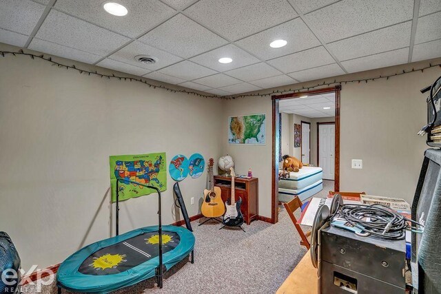 game room with a paneled ceiling and carpet floors