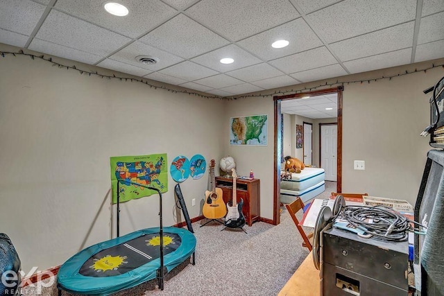 rec room with a paneled ceiling and carpet flooring