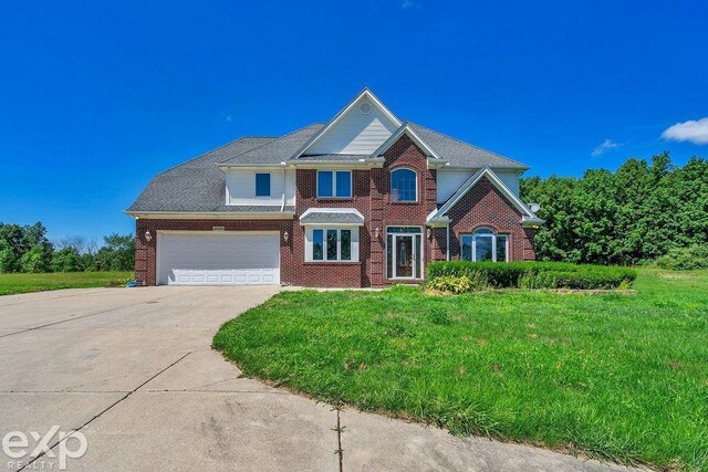 view of front of home with a garage and a front lawn