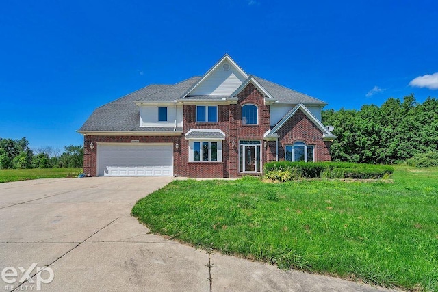 view of front of property featuring a garage and a front lawn