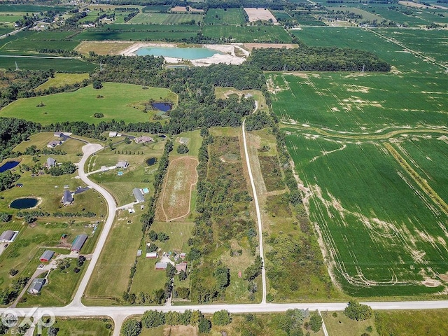 birds eye view of property with a rural view and a water view