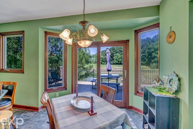 tiled dining space featuring a notable chandelier