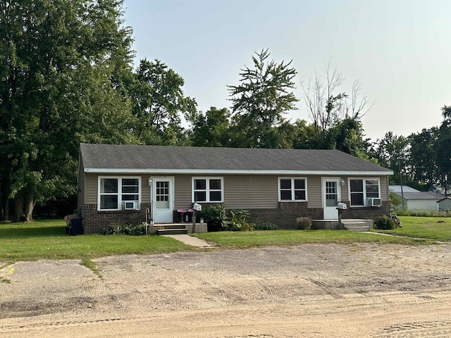 single story home featuring a front lawn and cooling unit