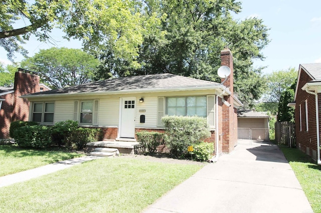 view of front of home with a front yard and a garage