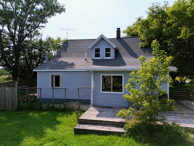 back of property with a yard and a deck