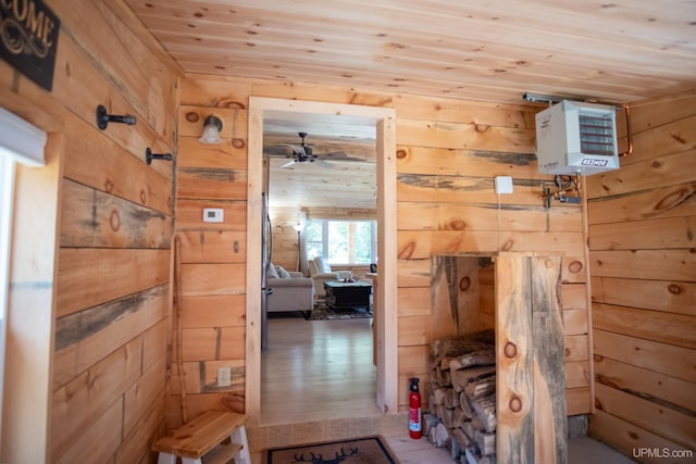 hallway featuring wooden walls, wooden ceiling, and hardwood / wood-style flooring