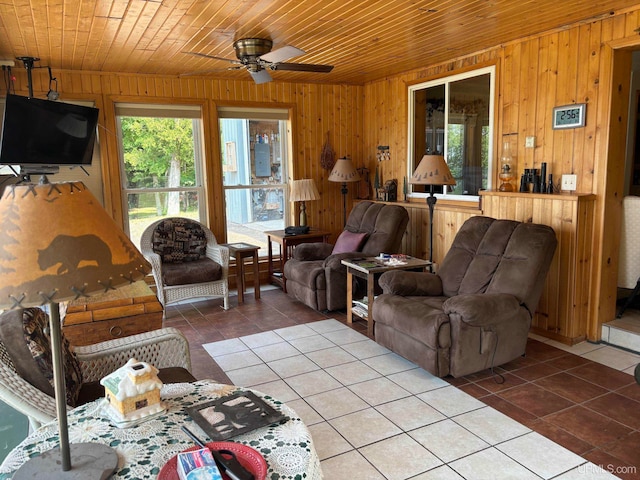 living room featuring wood ceiling, wooden walls, and tile patterned floors