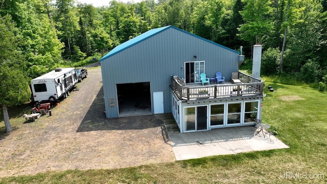 14998 N Superior Rd, Houghton, MI 49931 - rear view of house with a yard, a forest view, and a balcony