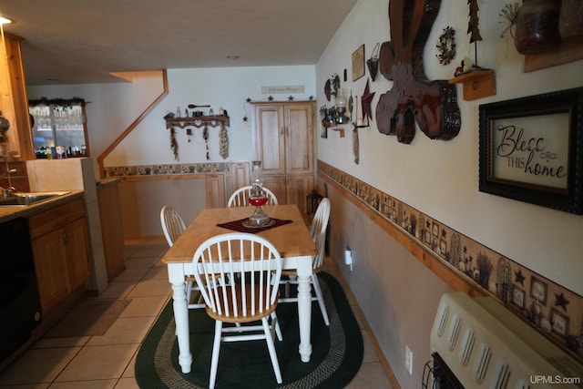 dining area with light tile patterned floors and sink