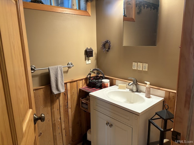 14998 N Superior Rd, Houghton, MI 49931 - bathroom with wainscoting, vanity, and wood walls