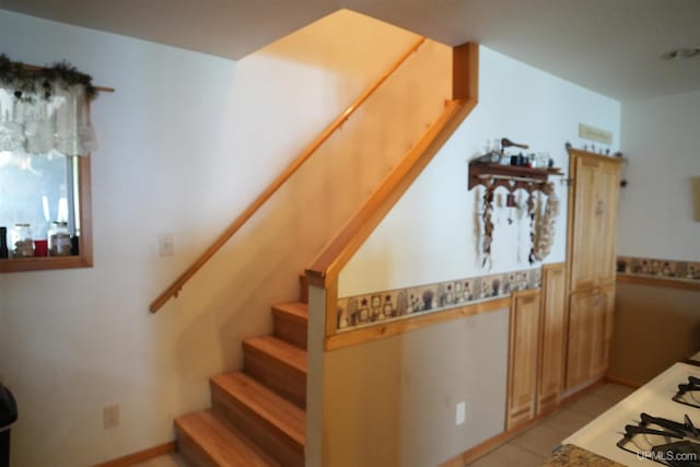 stairs with tile patterned floors