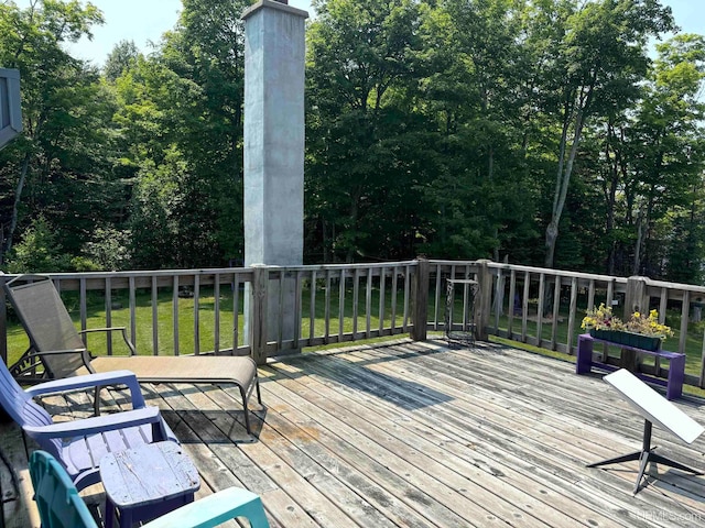 wooden terrace with a lawn