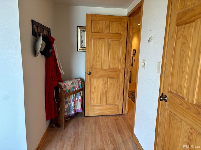 hallway with light hardwood / wood-style flooring