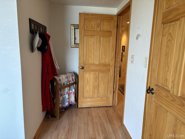 14998 N Superior Rd, Houghton, MI 49931 - hallway featuring light wood-style flooring and baseboards