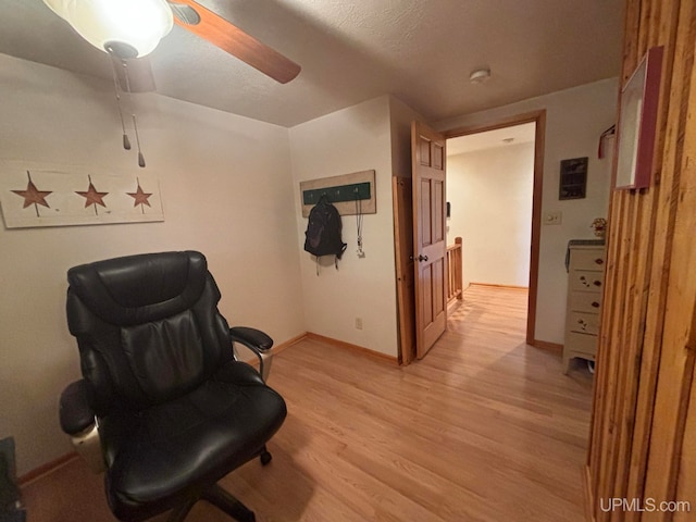 sitting room featuring ceiling fan and hardwood / wood-style floors