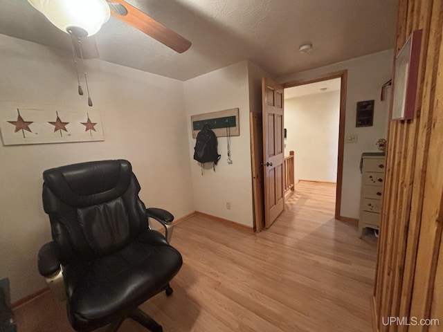 14998 N Superior Rd, Houghton, MI 49931 - living area featuring light wood-style floors, a ceiling fan, and baseboards