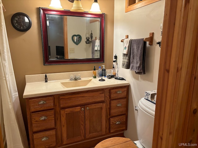 bathroom featuring toilet and vanity