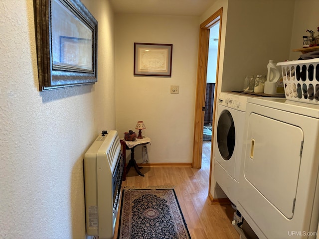 laundry area with light wood-type flooring and washing machine and dryer