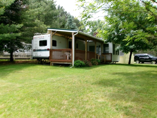 exterior space featuring a lawn and fence