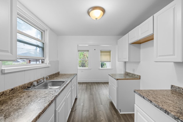 kitchen with sink, dark wood-type flooring, and white cabinetry