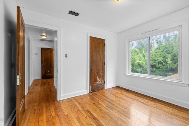 unfurnished bedroom with light wood-type flooring