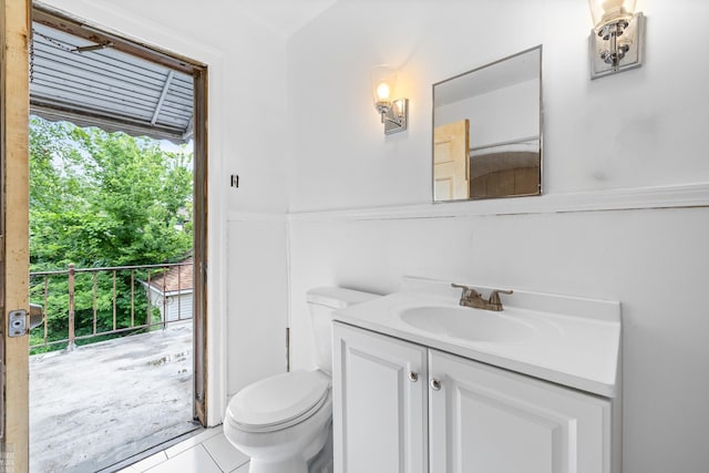 bathroom featuring tile patterned flooring, toilet, and vanity