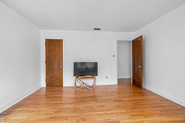 unfurnished living room with light hardwood / wood-style flooring