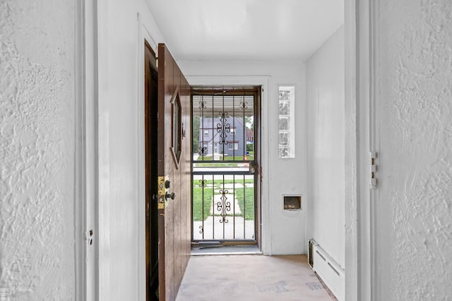 doorway with baseboard heating and light hardwood / wood-style floors