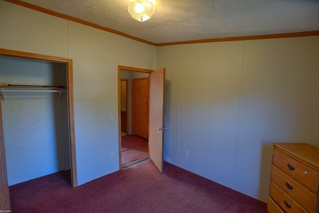 unfurnished bedroom featuring a closet, a textured ceiling, and carpet floors