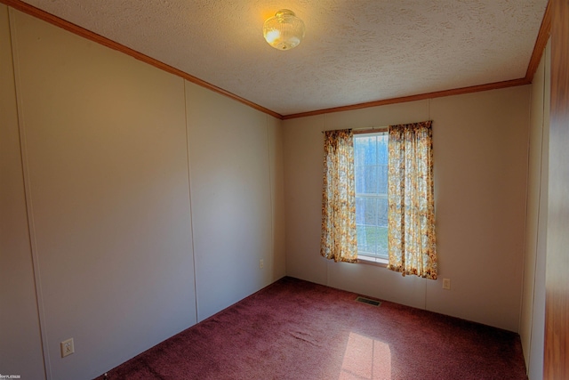 unfurnished room with a textured ceiling, carpet flooring, and ornamental molding