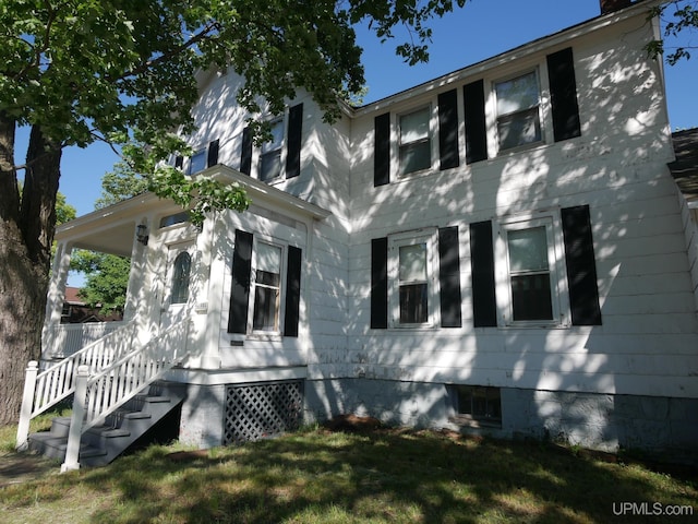 view of home's exterior featuring a yard and a chimney
