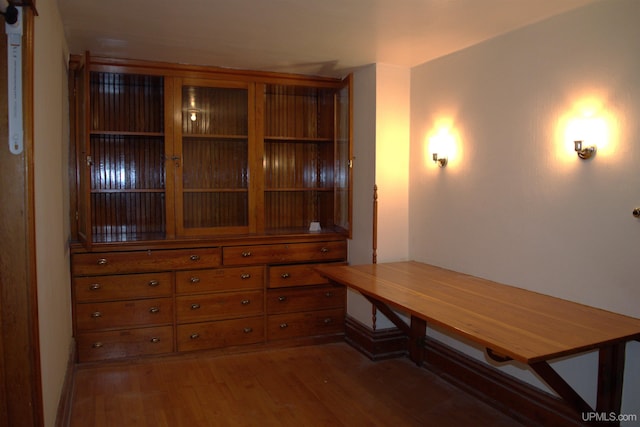 dining room featuring baseboards and wood finished floors