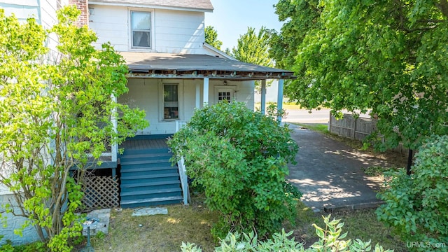 exterior space featuring covered porch and stairs