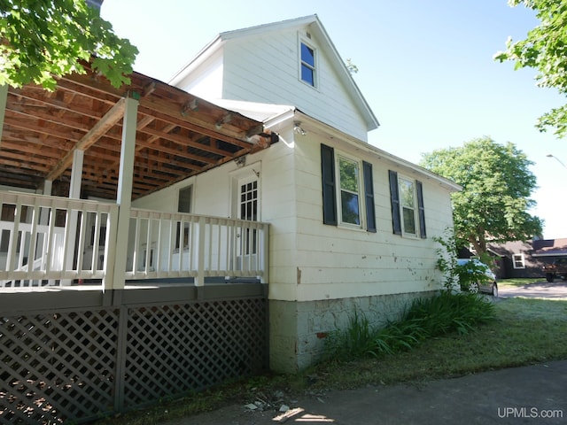 view of side of home with a wooden deck