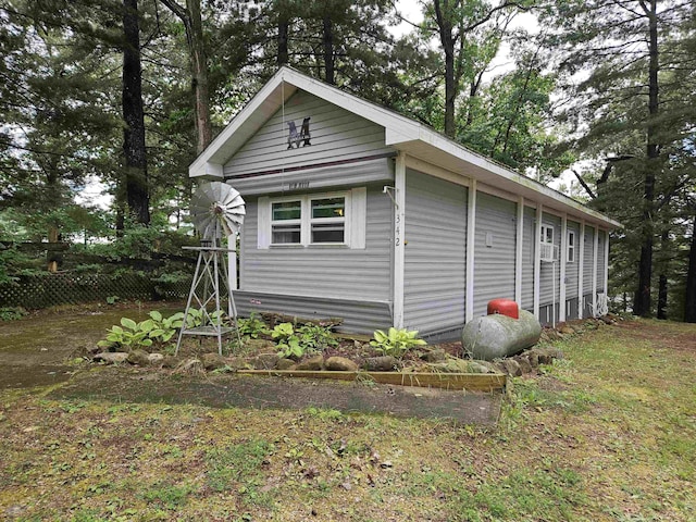 view of side of home featuring fence