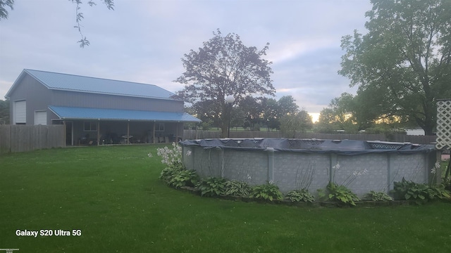 view of yard with a covered pool